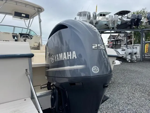 Slide: The Image of 1992 Grady-White Explorer 244 with Yamaha 250 outboard motor, displayed outdoors. - 26