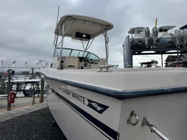 Slide: The Image of 1992 Grady-White Explorer 244 boat docked at marina under cloudy sky. - 27