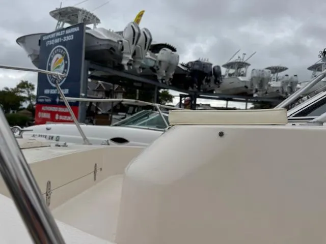 Slide: The Image of 1992 Grady-White Explorer 244 boat interior with helm, seating, and overcast sky. - 5