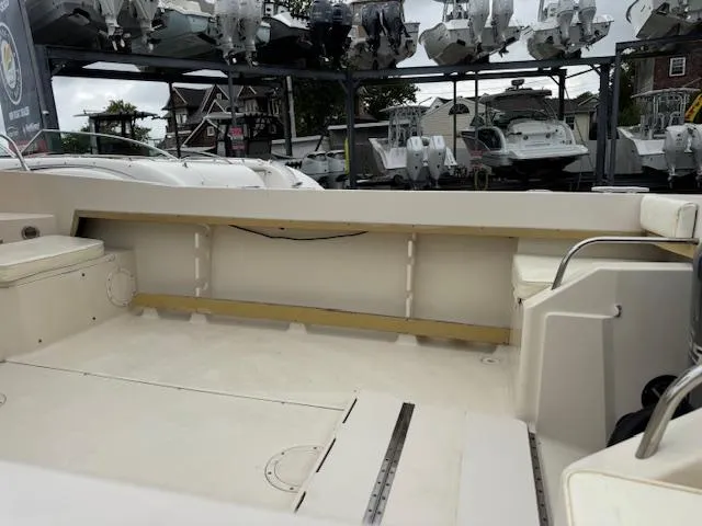 Slide: The Image of 1992 Grady-White Explorer 244 boat on display in a marina setting. - 6