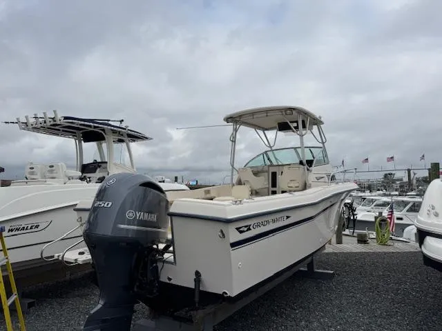 Slide: The Image of 1992 Grady-White Explorer 244 boat with Yamaha engine, docked at a marina. - 8
