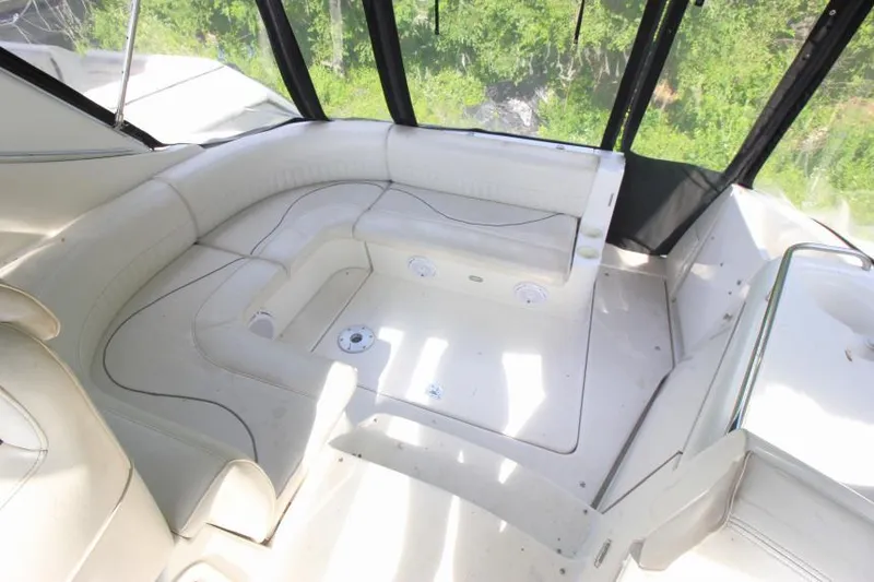 Slide: The Image of 2001 Cruisers Yachts 3470 Express interior with white seating and natural light. - 10