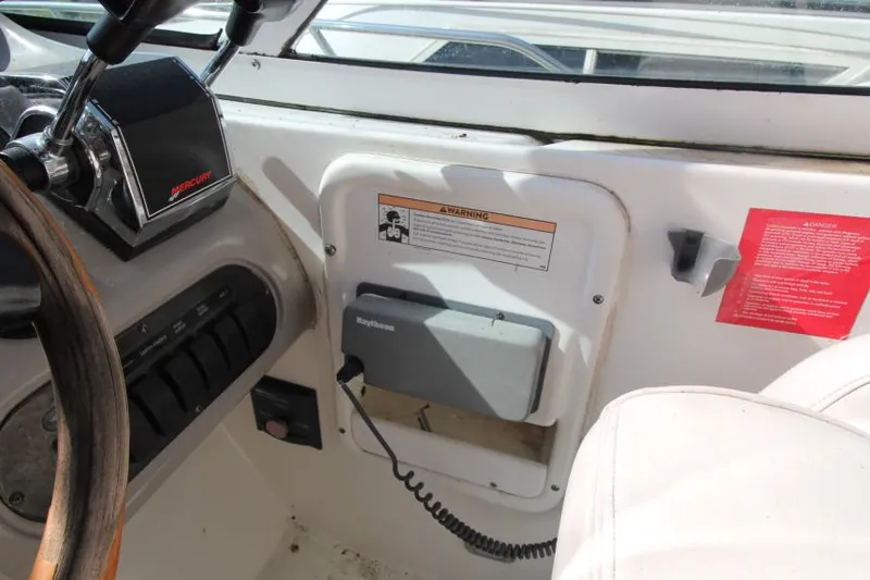 Slide: The Image of 2001 Cruisers Yachts 3470 Express helm with Mercury controls and Raytheon equipment. - 13