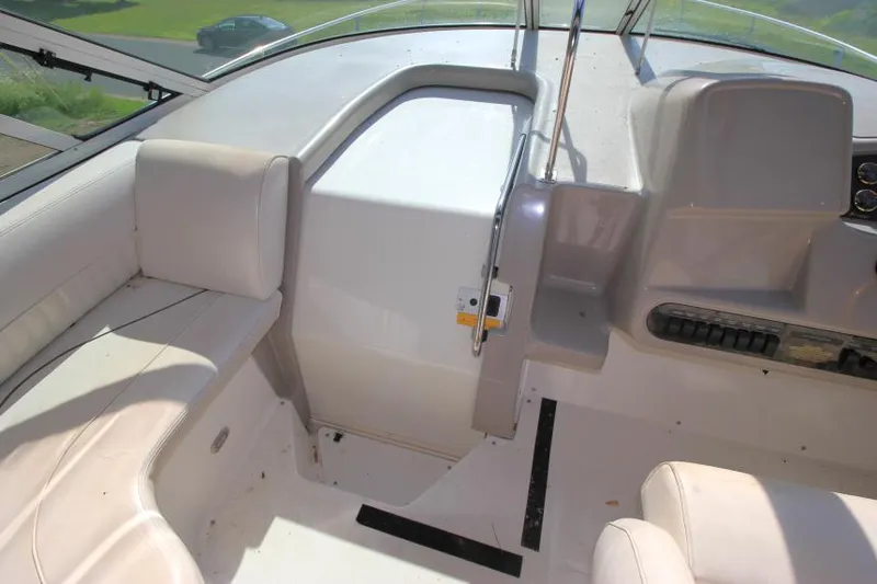 Slide: The Image of 2001 Cruisers Yachts 3470 Express cockpit with white seating and control panel. - 14