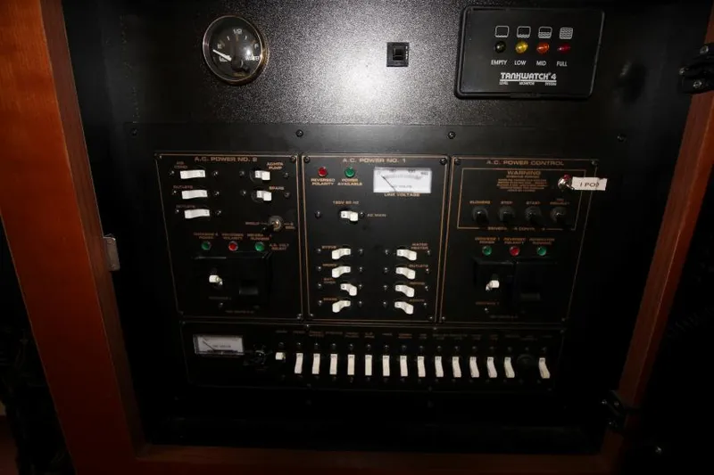 Slide: The Image of Control panel of a 2001 Cruisers Yachts 3470 Express, featuring switches and gauges. - 22