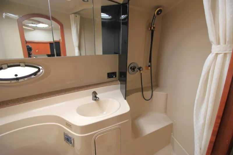 Slide: The Image of 2001 Cruisers Yachts 3470 Express bathroom with sink, shower, and mirror. - 23