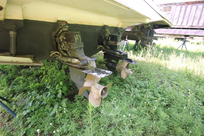Slide: The Image of 2001 Cruisers Yachts 3470 Express propellers and drives on grassy surface. - 4