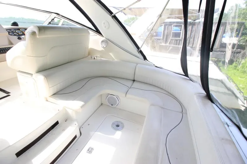 Slide: The Image of 2001 Cruisers Yachts 3470 Express interior with white leather seating and panoramic windows. - 5