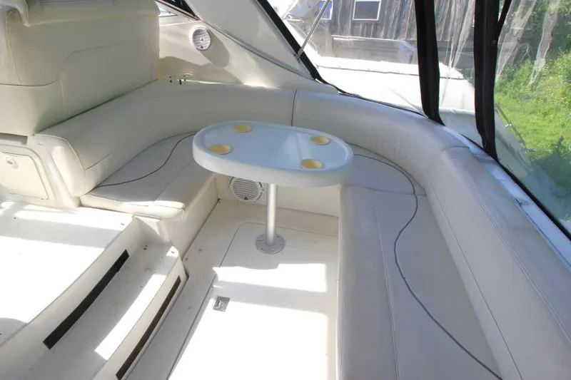 Slide: The Image of 2001 Cruisers Yachts 3470 Express interior with white seating and table. - 6