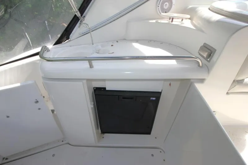 Slide: The Image of 2001 Cruisers Yachts 3470 Express interior with mini fridge and speaker. - 8