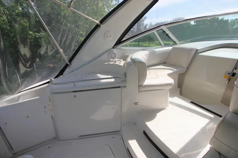Slide: The Image of 2001 Cruisers Yachts 3470 Express interior with white seating and clear windows. - 9