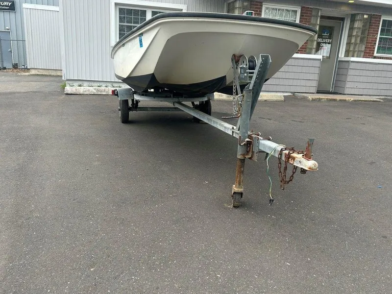 Slide: The Image of 1983 Boston Whaler Sport boat on trailer in parking lot. - 10