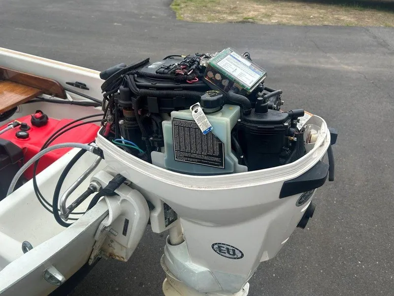 Slide: The Image of 1983 Boston Whaler Sport outboard motor, detailed view, showcasing engine components and wiring. - 11