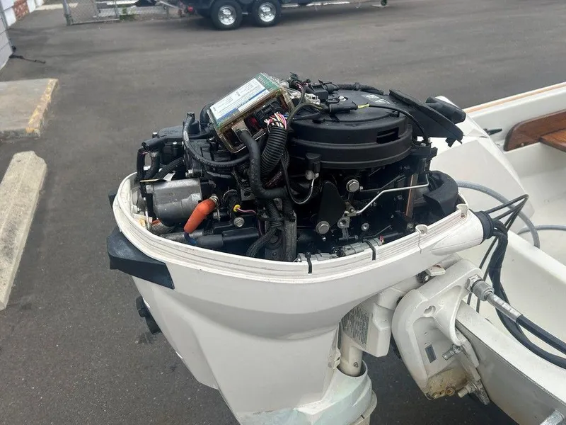 Slide: The Image of 1983 Boston Whaler Sport outboard motor, detailed view of engine components. - 14