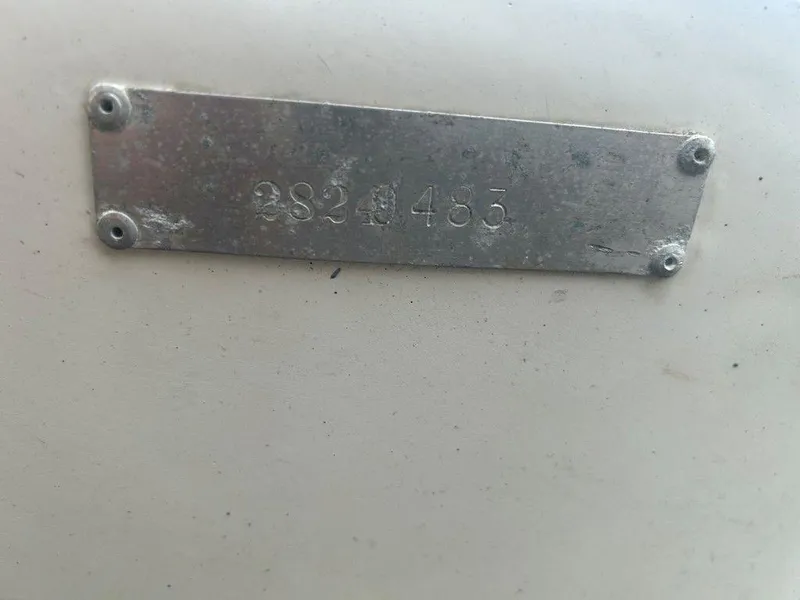 Slide: The Image of Metal identification plate on 1983 Boston Whaler Sport boat, showing serial number 2824 483. - 15