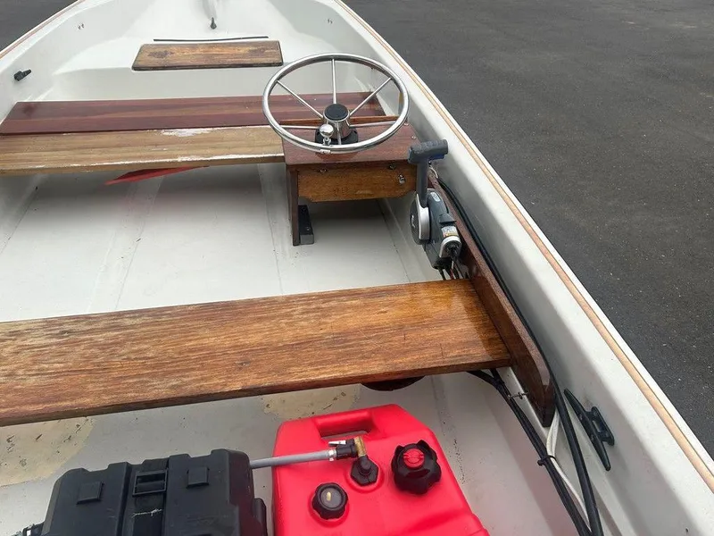 Slide: The Image of 1983 Boston Whaler Sport boat interior with wooden seats and steering wheel. - 16