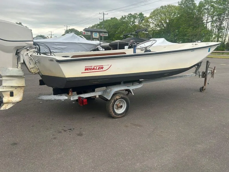 Slide: The Image of 1983 Boston Whaler Sport boat on trailer, parked outdoors. - 2