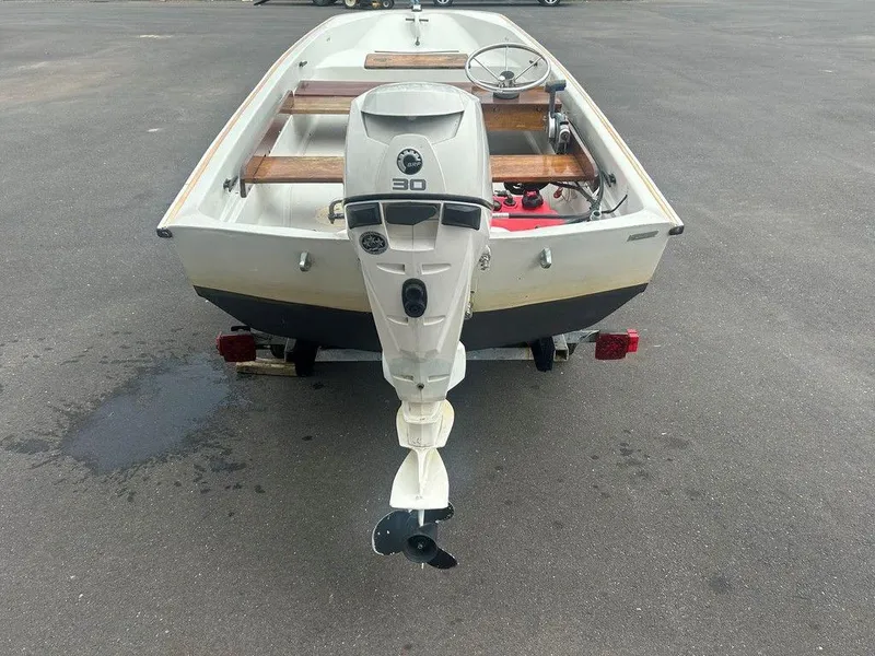 Slide: The Image of 1983 Boston Whaler Sport boat with outboard motor on a trailer. - 7