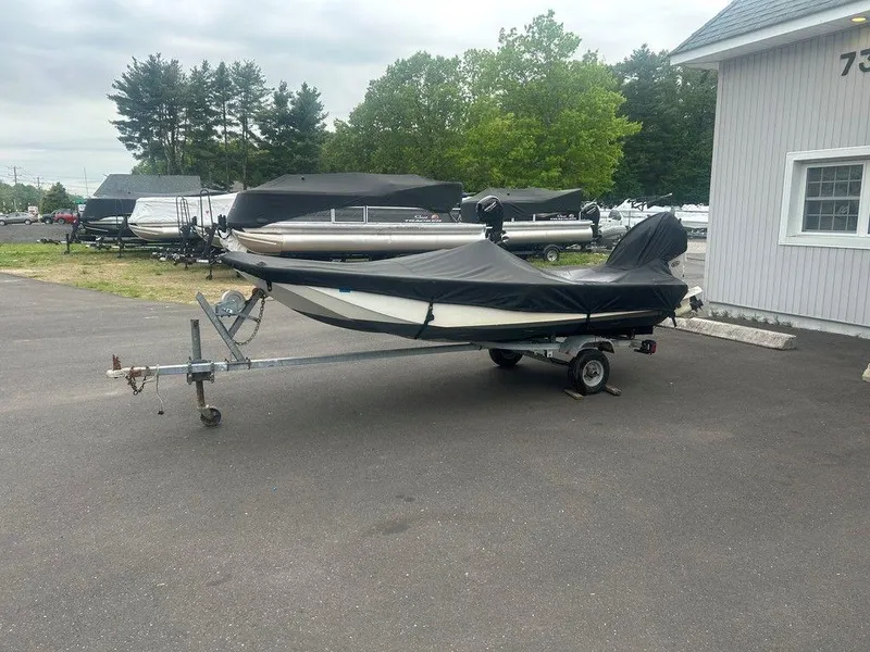 Slide: The Image of 1983 Boston Whaler Sport boat on trailer, covered, parked outside dealership. - 9