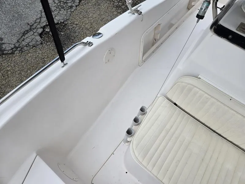 Slide: The Image of 2002 Grady-White 209 ESCAPE boat interior with white seating and rod holders. - 11