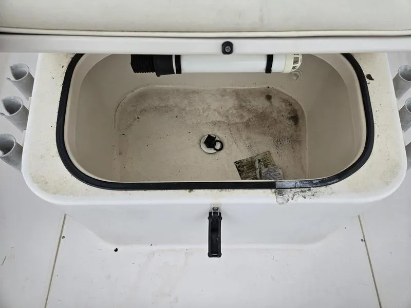 Slide: The Image of Open storage compartment on 2002 Grady-White 209 ESCAPE boat, showing interior details. - 12