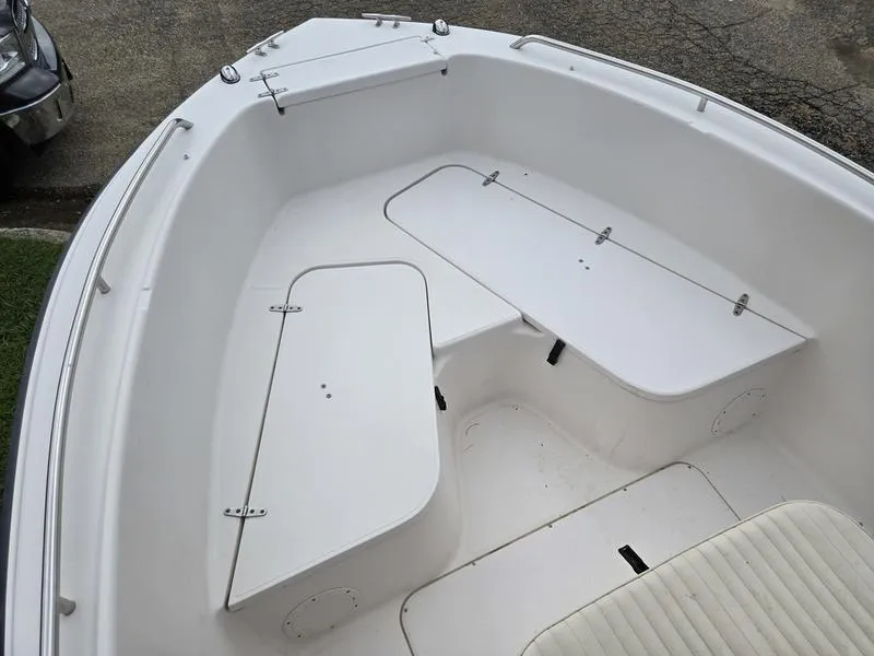 Slide: The Image of 2002 Grady-White 209 ESCAPE boat interior with white seating and storage compartments. - 5