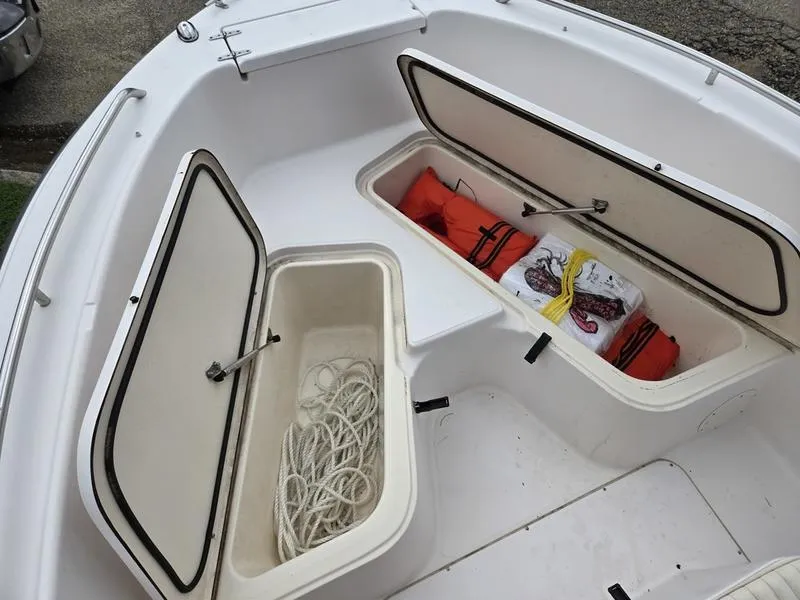 Slide: The Image of 2002 Grady-White 209 ESCAPE boat storage compartments with ropes and life jackets. - 7