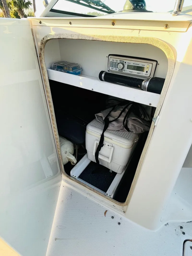 Slide: The Image of Storage compartment in a 2005 Sea Ray 240 Sundeck with cooler and radio. - 10