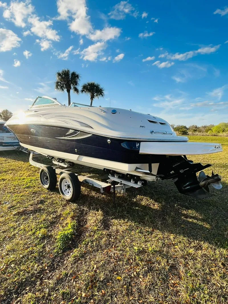 Slide: The Image of 2005 Sea Ray 240 Sundeck boat on trailer under blue sky. - 3