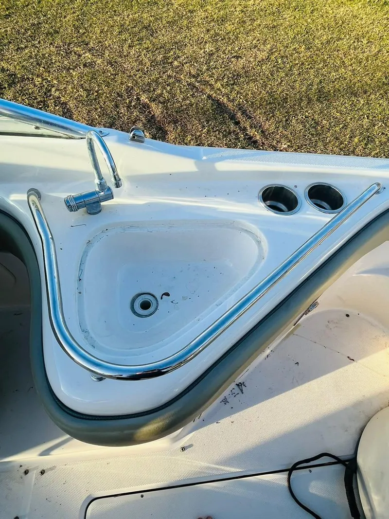 Slide: The Image of 2005 Sea Ray 240 Sundeck boat sink with faucet and cup holders. - 9