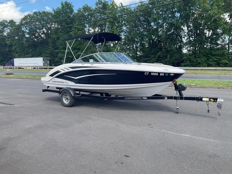 Slide: The Image of 2018 Chaparral 203 VR boat on trailer, parked on asphalt near trees. - 10