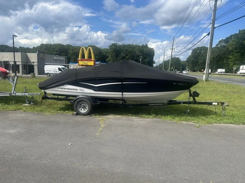 Slide: The Image of 2018 Chaparral 203 VR boat on trailer, covered, near McDonald's, under cloudy sky. - 11