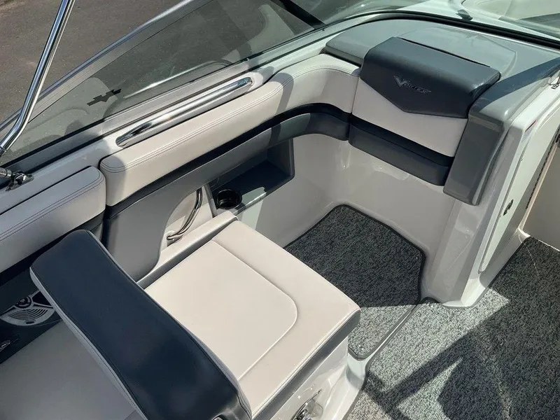Slide: The Image of 2018 Chaparral 203 VR boat interior with gray seating and carpeted flooring. - 21