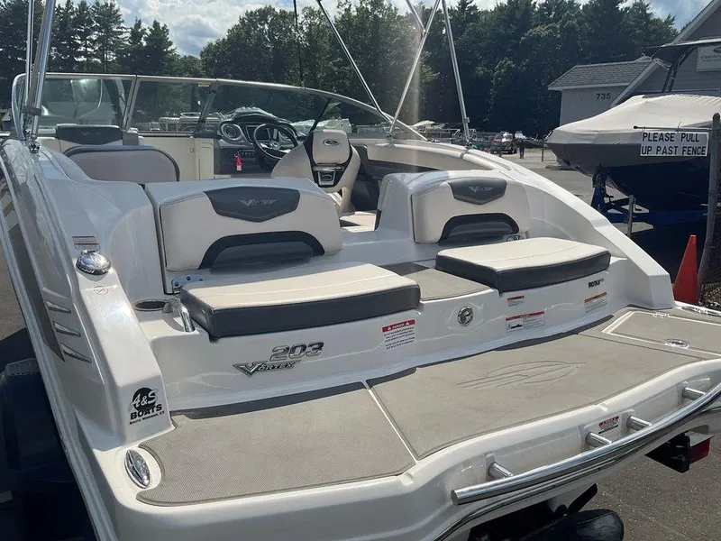 Slide: The Image of 2018 Chaparral 203 VR boat with seating, docked outdoors on a sunny day. - 4