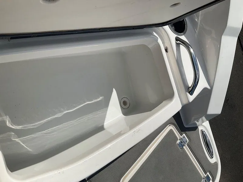 Slide: The Image of 2018 Chaparral 203 VR boat storage compartment with stainless steel handle. - 5
