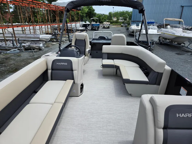 Slide: The Image of 2026 Harris Cruiser 230 pontoon boat with spacious seating, docked in a marina. - 10