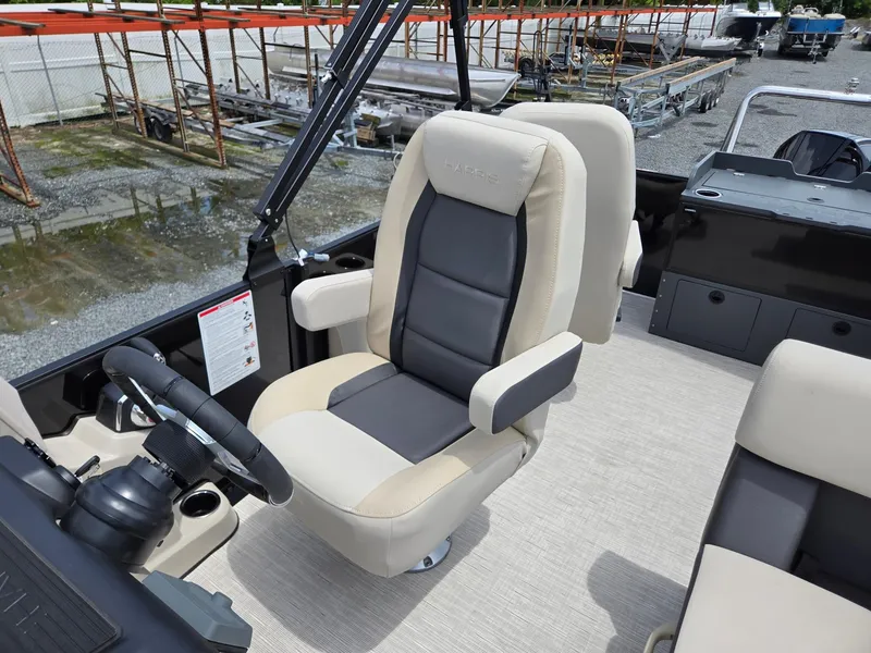 Slide: The Image of Captain's chair on 2026 Harris Cruiser 230 boat, featuring beige and black upholstery. - 15