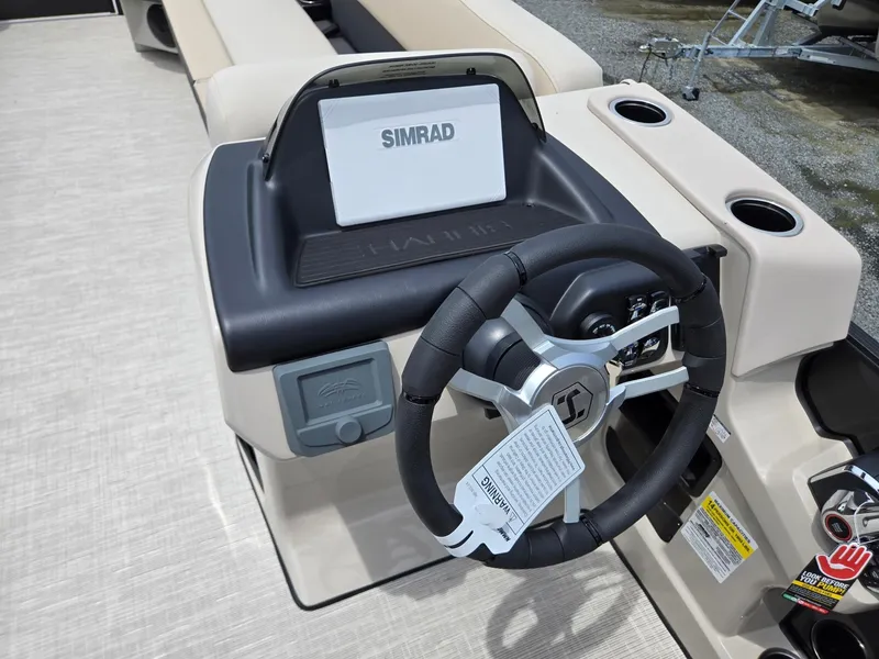 Slide: The Image of 2026 Harris Cruiser 230 boat dashboard with steering wheel and Simrad display. - 16