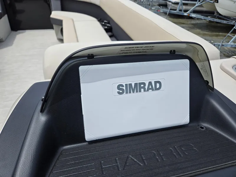 Slide: The Image of 2026 Harris Cruiser 230 boat dashboard with Simrad navigation system. - 17