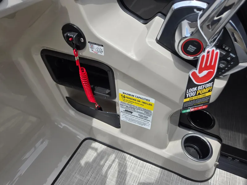 Slide: The Image of 2026 Harris Cruiser 230 boat dashboard with safety features and fuel warning tag. - 20