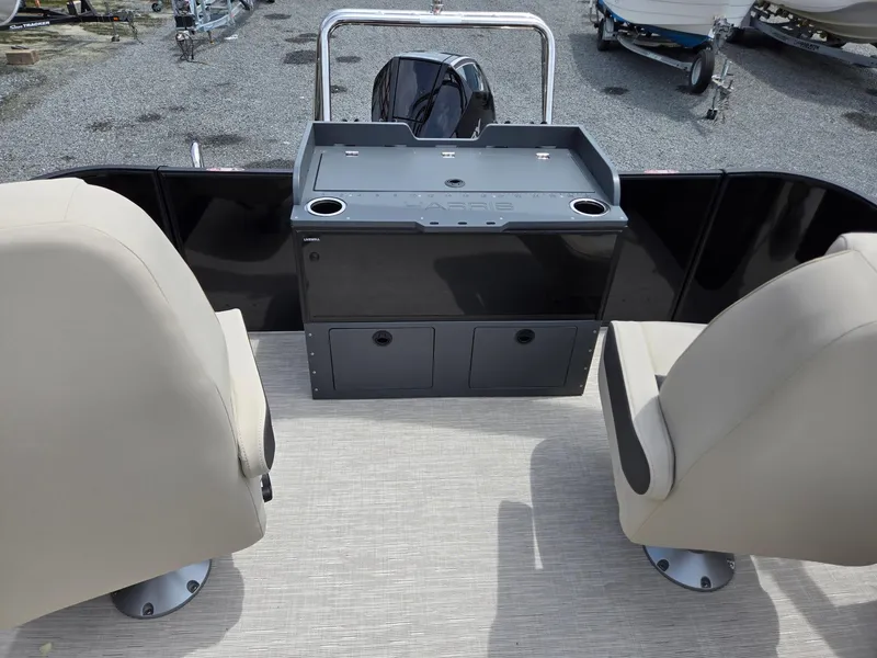Slide: The Image of 2026 Harris Cruiser 230 boat interior with beige seats and storage console. - 22