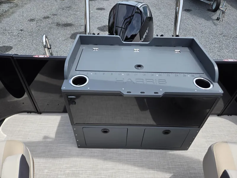 Slide: The Image of 2026 Harris Cruiser 230 boat with livewell and storage compartments, featuring a sleek design. - 24