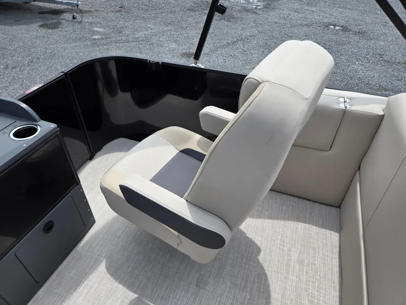 Slide: The Image of 2026 Harris Cruiser 230 boat interior with beige seating and console. - 25
