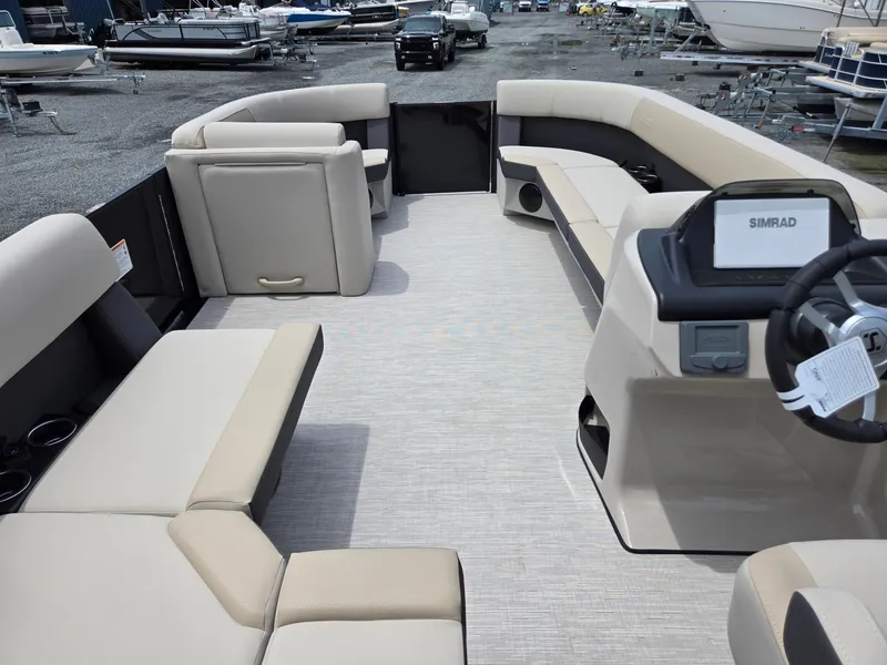 Slide: The Image of 2026 Harris Cruiser 230 pontoon boat interior with beige seating and modern dashboard. - 31