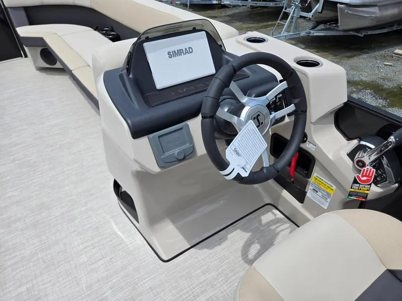 Slide: The Image of 2026 Harris Cruiser 230 boat interior with steering wheel and Simrad display. - 32