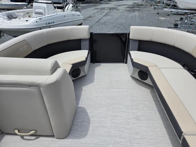 Slide: The Image of 2026 Harris Cruiser 230 boat interior with beige seating and spacious layout. - 33