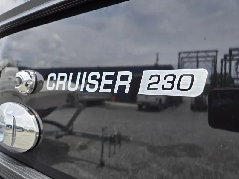 Slide: The Image of 2026 Harris Cruiser 230 boat emblem on reflective surface. - 38