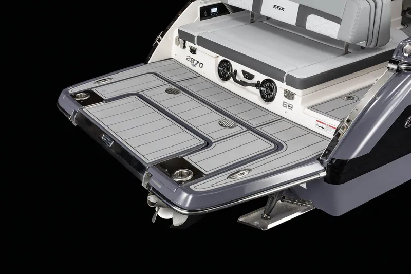 Slide: The Image of 2025 Chaparral 2870 boat swim platform with seating and speakers, showcasing modern design. - 2