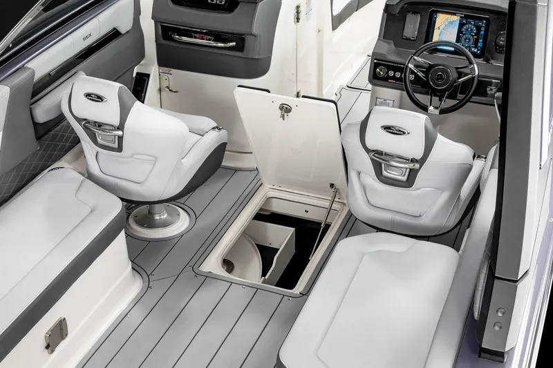 Slide: The Image of 2025 Chaparral 2870 boat interior with modern seating and open storage compartment. - 7