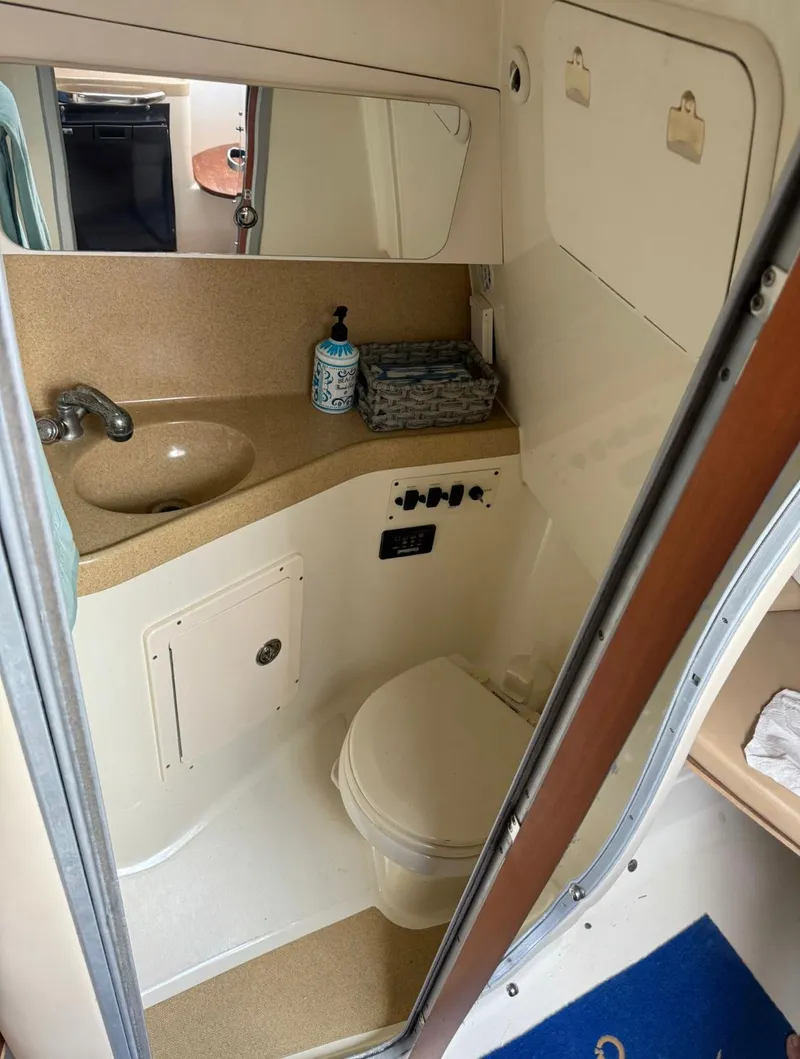 Slide: The Image of Compact bathroom in 2008 Hydra-Sports Vector 2800 WA boat, featuring sink and toilet. - 8